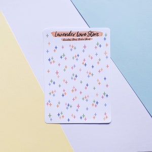 May include: A sheet of rainbow star stickers with the text "Lavender Love Store" and "Rainbow Stars Sticker Sheet".