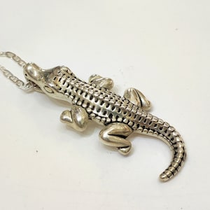 Silver pendant crocodile design with silver chain.