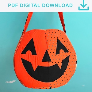 May include: A fabric pumpkin-shaped treat bag featuring a jack-o'-lantern face with black triangular eyes, a triangular nose, and a wide grin. The bag has orange fabric panels, one solid and one with black polka dots, and a handle. Text reads PDF DIGITAL DOWNLOAD.