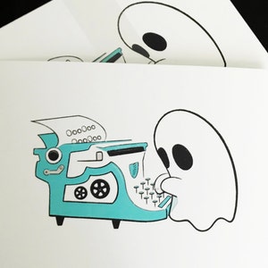 May include: A white ghost with black eyes is typing on a teal typewriter with a white paper in the carriage. The typewriter has a black lever and a black wheel.