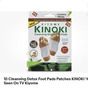 May include: A package of KIYOME KINOKI Cleansing Detox Foot Pads. The package is white with green accents and features a picture of a foot with a foot pad on it. The text on the package reads "Cleanse & Energize Your Body" and "Only by one night while you sleep".