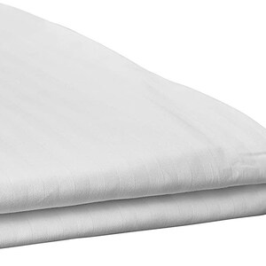 May include: A white, folded, striped sheet. The sheet is made of a soft, smooth fabric.