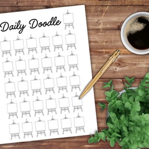 May include: A white paper with the words "Daily Doodle" and a grid of small easel drawings. A gold pen, a cup of coffee, and a small plant are on a wooden surface.