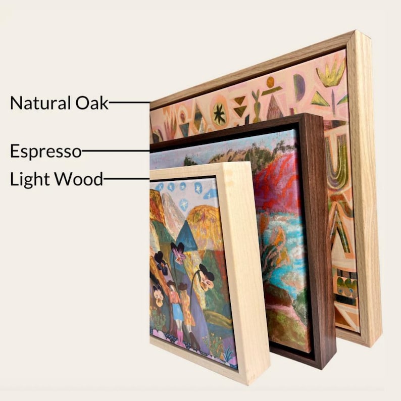 three framed artworks, each with a different type of wood and frame, including natural oak, espresso, and light wood.