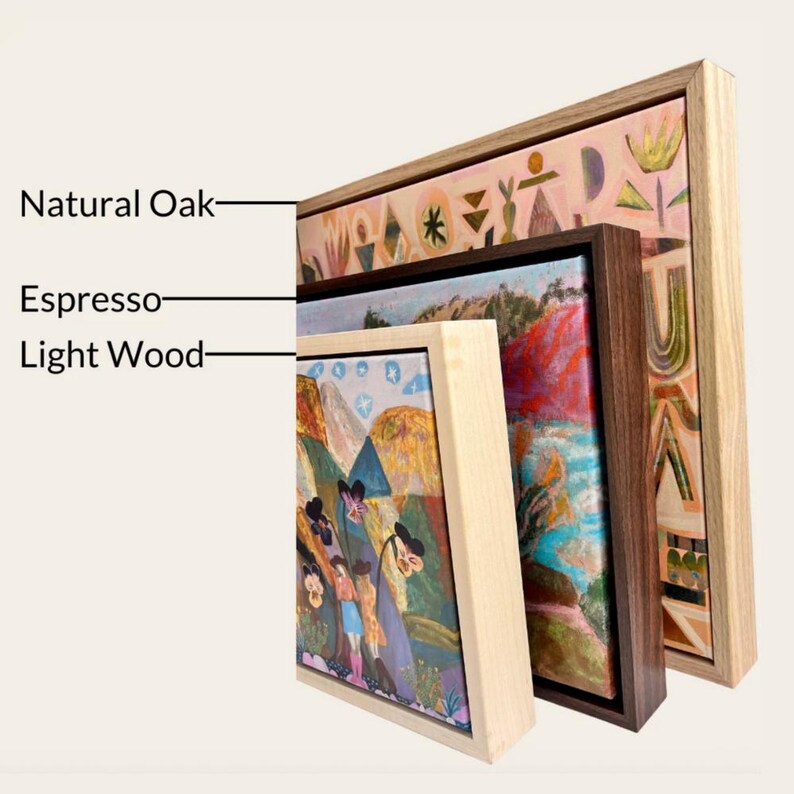 three framed artworks, each with a different type of wood and frame, including natural oak, espresso, and light wood.