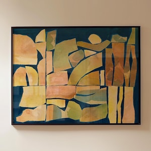 May include: Abstract art piece in a dark brown frame. The artwork features a collage of geometric shapes in shades of yellow, orange, and green against a dark blue background. The shapes are arranged in a seemingly random pattern.