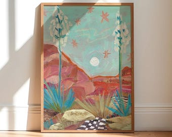 May include: A framed painting depicting a desert landscape with two tall white yucca plants, red rock formations, a pale moon, and pink star shapes against a light blue sky. The foreground features tan rocks and a black and white checkered pattern.