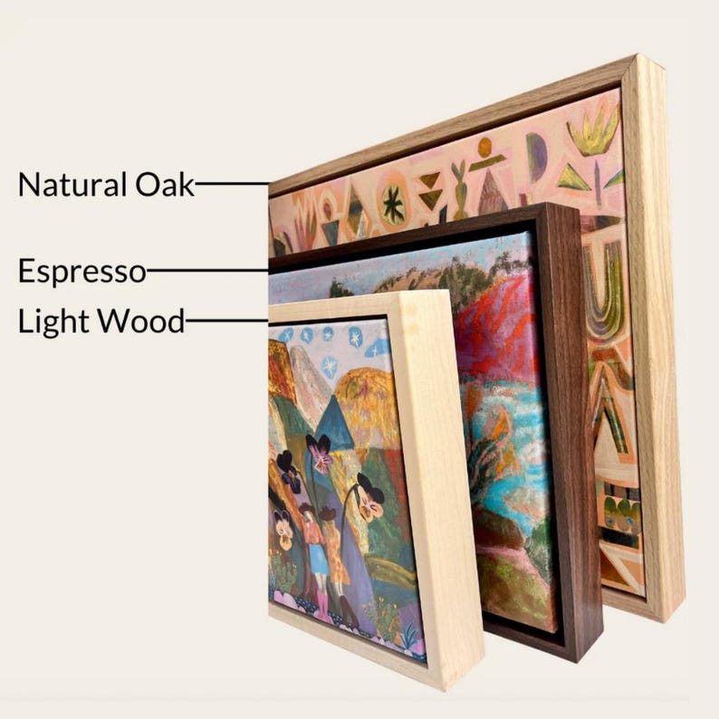 three framed artworks, each with a different type of wood and frame, including natural oak, espresso, and light wood.