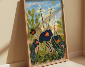 May include: A framed rectangular art print featuring a desert landscape painting with green prickly pear cacti, tall cream-colored yucca flowers, and large dark navy blue blossoms with orange centers under a light blue sky with a small yellow sun.