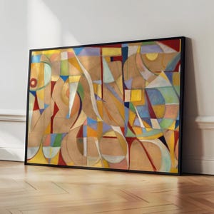 May include: A rectangular framed wall art piece featuring an abstract composition of geometric shapes and curved lines in shades of tan, gold, blue, red, yellow, and light green, enclosed within a thin black frame against a plain wall.