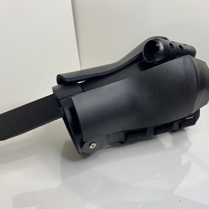 Puede incluir: Férula de muñeca de plástico negro con correas ajustables y una sección acolchada. La férula tiene una pequeña palanca de plástico negro en el lateral.