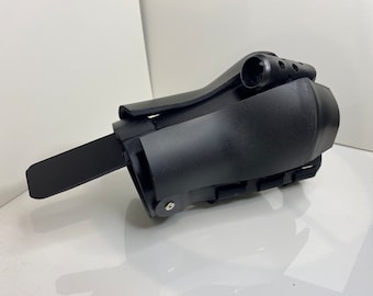 May include: Black plastic wrist brace with adjustable straps and a padded section. The brace has a small, black, plastic lever on the side.