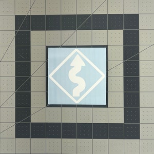 May include: White sticker featuring a winding road symbol with an upward-pointing arrow, enclosed within a white diamond shape. The sticker is on a light blue background, set against a gray and black grid.