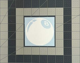 May include: White vinyl sticker of a white billiard ball with a black number eight on a blue background.