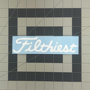 May include: A light blue vinyl sticker with the word "Filthiest" written in white cursive lettering.