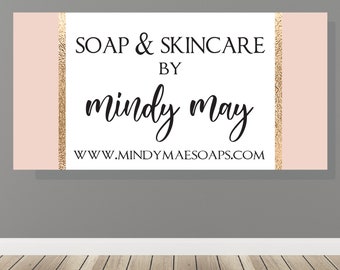 May include: A pink and white business card with gold glitter accents. The text reads "Soap & Skincare by Mindy May" and "www.mindymaesoaps.com".