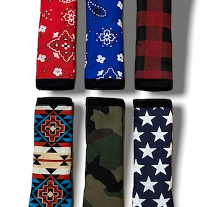 May include: Six different patterned golf club head covers. The covers are made of fabric and have a variety of designs, including paisley, plaid, camouflage, and stars.