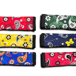 May include: Six colorful fabric sleeves with paisley patterns and team logos. The sleeves are designed to fit over a standard-sized water bottle.