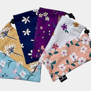 May include: Set of six drawstring pouches with floral patterns. The pouches are in various colors, including blue, purple, yellow, white, and pink. Each pouch has a different floral design.