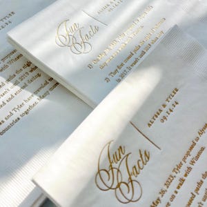 a close up of a paper with gold lettering on it