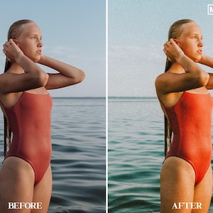 May include: A woman in a red swimsuit stands in the water, looking to the right. The water is a light blue color and the sky is a light blue color. The woman has long brown hair and is wearing a red swimsuit. The image is taken from a low angle.