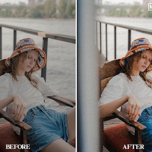 May include: A person wearing a colorful crocheted bucket hat, a white t-shirt, and blue denim shorts sits on a wooden chair. The person is looking down and has their hands in their lap. The chair is on a wooden deck with a railing in the background.