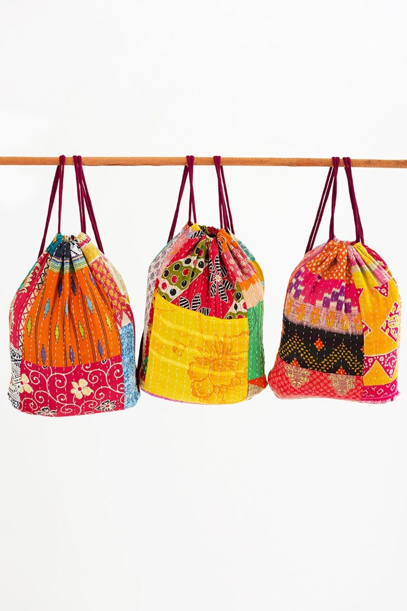large kantha bag, colorful fun purse, tote shoulder bag, hippie boho style, features bright geometric patterns, casual every day bag, made in india, made by artisans, soft cotton material, handheld bag, long straps, drawstring bookbag, festival purse