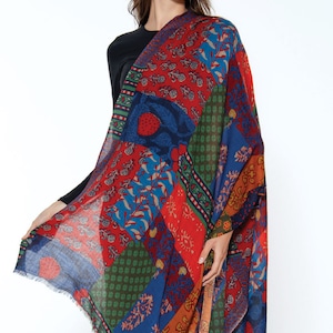 May include: A colorful patchwork scarf with a variety of floral and geometric patterns in shades of red, blue, green, and orange.