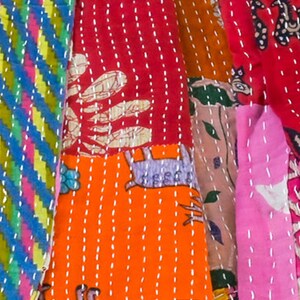 long patchwork scarf, colorful fun accessory, hippie boho style, features bright geometric patterns, casual every day scarf, made in india, made by artisans, soft cotton material, end strings, warm winter wrap, kantha fabric