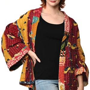 A vibrant patchwork kimono-style jacket featuring a fun mix of colors and patterns, including bright tones with floral, geometric, and abstract designs. The jacket has wide sleeves, a relaxed fit, and visible hand-stitching, creating a boho look.