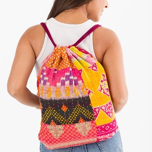 large kantha bag, colorful fun purse, tote shoulder bag, hippie boho style, features bright geometric patterns, casual every day bag, made in india, made by artisans, soft cotton material, handheld bag, long straps, drawstring bookbag, festival purse