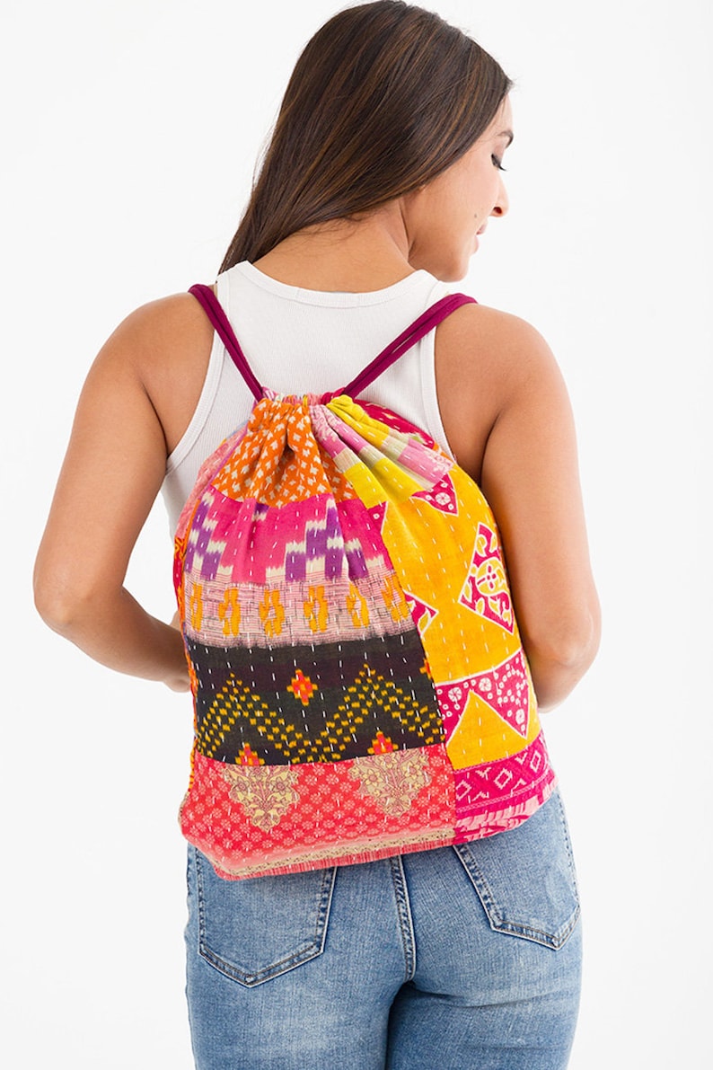 large kantha bag, colorful fun purse, tote shoulder bag, hippie boho style, features bright geometric patterns, casual every day bag, made in india, made by artisans, soft cotton material, handheld bag, long straps, drawstring bookbag, festival purse