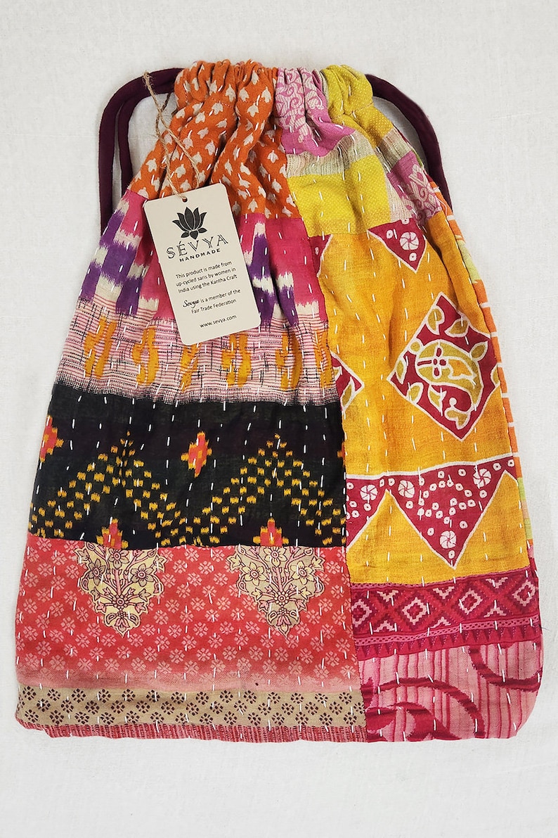 large kantha bag, colorful fun purse, tote shoulder bag, hippie boho style, features bright geometric patterns, casual every day bag, made in india, made by artisans, soft cotton material, handheld bag, long straps, drawstring bookbag, festival purse