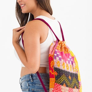 large kantha bag, colorful fun purse, tote shoulder bag, hippie boho style, features bright geometric patterns, casual every day bag, made in india, made by artisans, soft cotton material, handheld bag, long straps, drawstring bookbag, festival purse