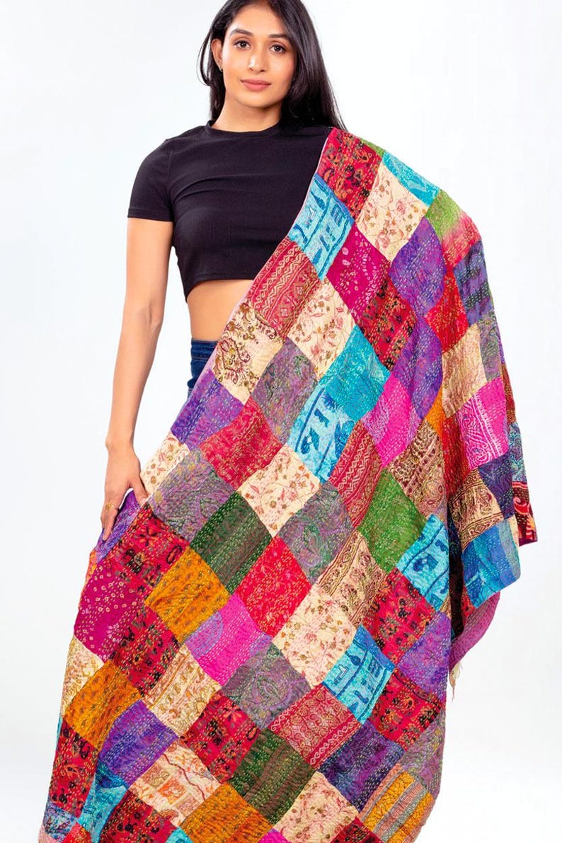 May include: A large rectangular shawl featuring a vibrant patchwork design composed of numerous square fabric panels in various colours including magenta, turquoise, green, yellow, and cream, each decorated with intricate floral and geometric patterns.