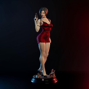 May include: A detailed figurine of a woman in a red dress, holding a gun. The figure has short dark hair and is standing on a round base with a symbol. The background is dark with red and blue lighting.