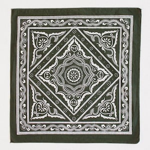 May include: Dark green bandana with a white ornate design. The square bandana features a central diamond pattern with floral and scroll details, surrounded by a decorative border. The design is symmetrical and detailed, creating a classic aesthetic.