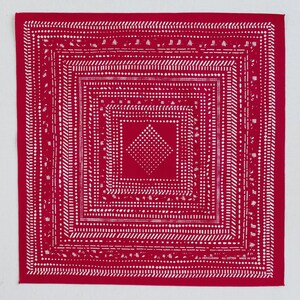 May include: Red square bandana with a white geometric pattern. The design features concentric squares with dotted and dashed lines, and a central diamond shape. The bandana is made of cotton and has text that reads "ALL COTTON MADE IN USA".