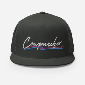 Pu&ograve; includere: Cappellino da camionista grigio scuro con retro in rete e visiera piatta. Il cappello presenta la scritta ricamata "Cowpuncher" in corsivo bianco, con linee blu e rosa sottostanti. Un piccolo disegno a forma di cuore &egrave; a destra.