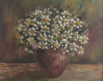 May include: A bouquet of white daisies in a brown ceramic vase. The flowers are arranged in a loose, natural style, and the vase is simple and elegant.