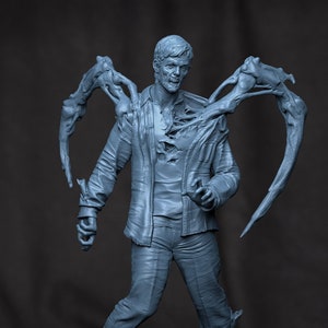 May include: A grey 3D printed figurine of a person with a ripped shirt and wings growing out of their back.