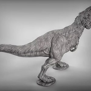 May include: A gray, detailed, plastic model of a Tyrannosaurus Rex dinosaur with its mouth open in a roar. The dinosaur is standing on a gray base.