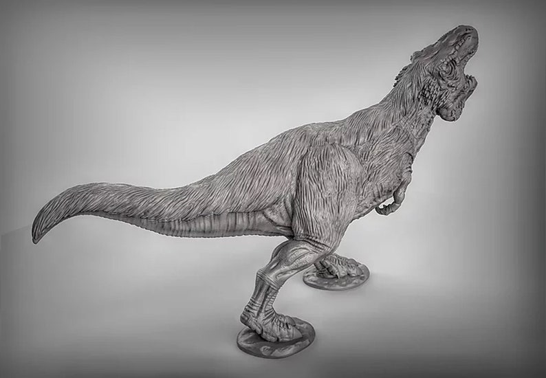 May include: A gray, detailed, plastic model of a Tyrannosaurus Rex dinosaur with its mouth open in a roar. The dinosaur is standing on a gray base.