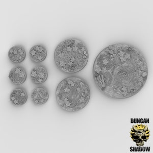 May include: A set of eight grey resin miniature bases with a woodland theme. The bases feature a variety of leaves and other details. The bases are perfect for use with miniature wargaming figures.