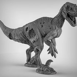 May include: A gray, detailed, plastic miniature of a velociraptor dinosaur with a damaged body and open mouth. The dinosaur is standing on a base with a textured surface.
