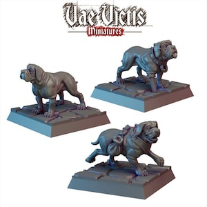 May include: Three gray miniature dog figurines on square bases. The dogs are in different poses, one standing, one walking, and one running. The text "Vae Victis Miniatures" is at the top.