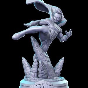 May include: A white 3D printed figurine of a superhero character from the anime My Hero Academia. The character is in a dynamic pose, kicking with one leg raised, and wearing a cape and a costume with a detailed design. The figurine is standing on a rocky base with the text "My Hero Academia" and Japanese characters.