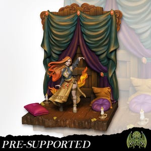 May include: A miniature fantasy figure of a woman with long red hair, wearing a gold and black outfit, with flames emanating from her side. The figure stands on a wooden platform with a backdrop of curtains and a door. The text "PRE-SUPPORTED" is at the bottom.