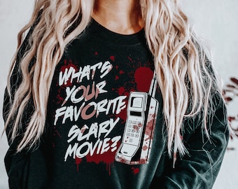 May include: Black sweatshirt with a red and white graphic of a vintage phone with blood splatters and the text "What's your favorite scary movie?"