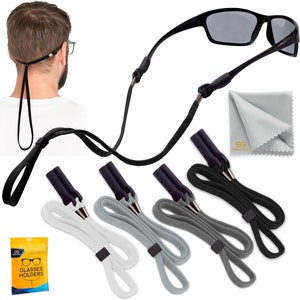 May include: Black sunglasses with a black glasses strap and a gray microfiber cleaning cloth. The image also shows four glasses straps in white, gray, dark gray, and black. A package of glasses holders is also visible.